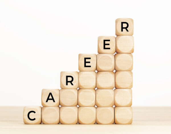 Career Growing concept. Text in wooden dices on table. White background. Copy space